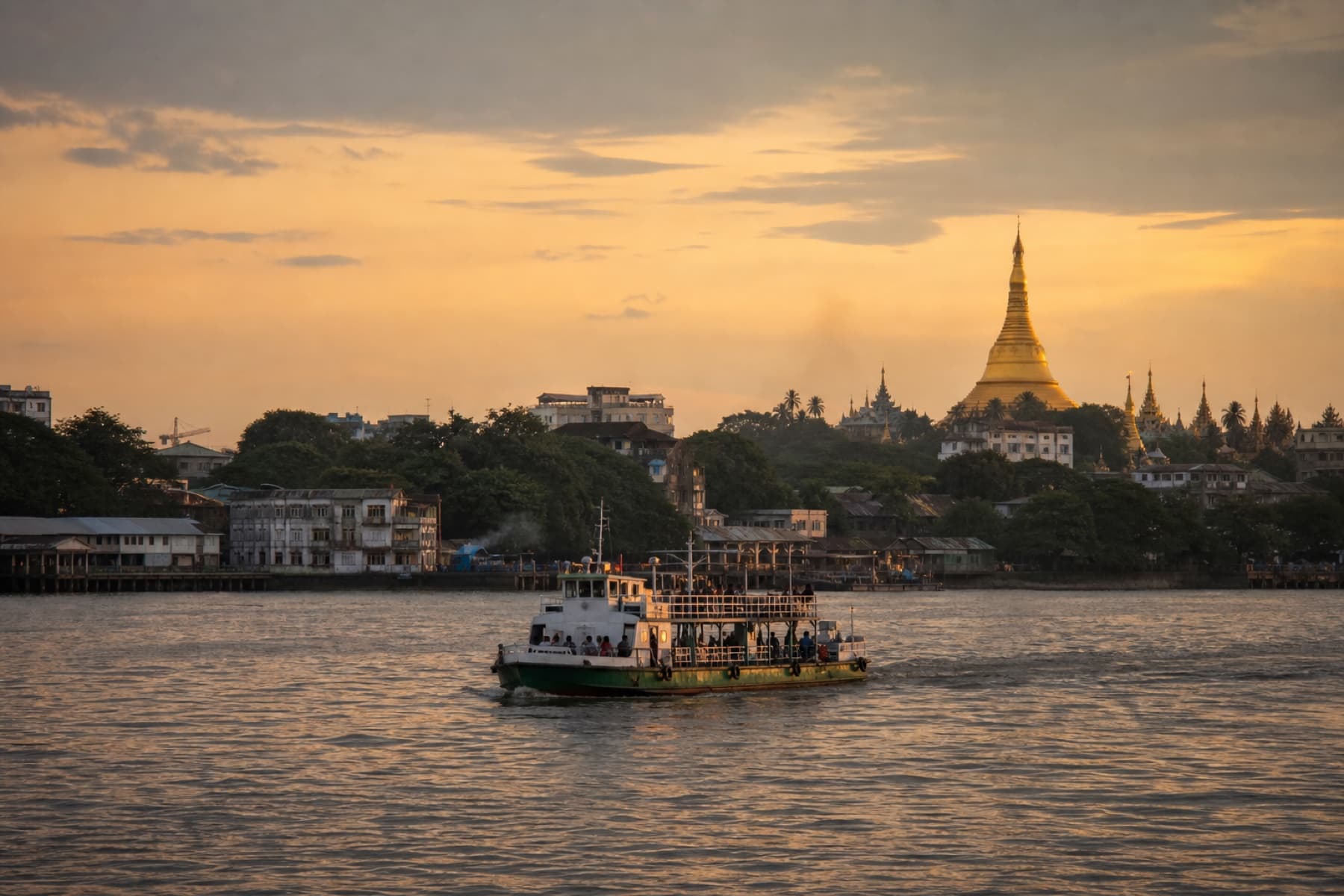 A ferry crossing the Yangon River at sunset